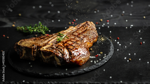 T-bone grilled beef steak. Dry Aged Barbecue Porterhouse Steak. Medium rare. American cuisine. Long banner format, top view photo