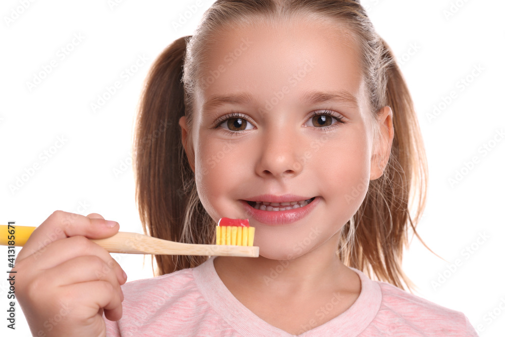 Little girl holding toothbrush with paste on white background Little girl holding toothbrush with paste on white background