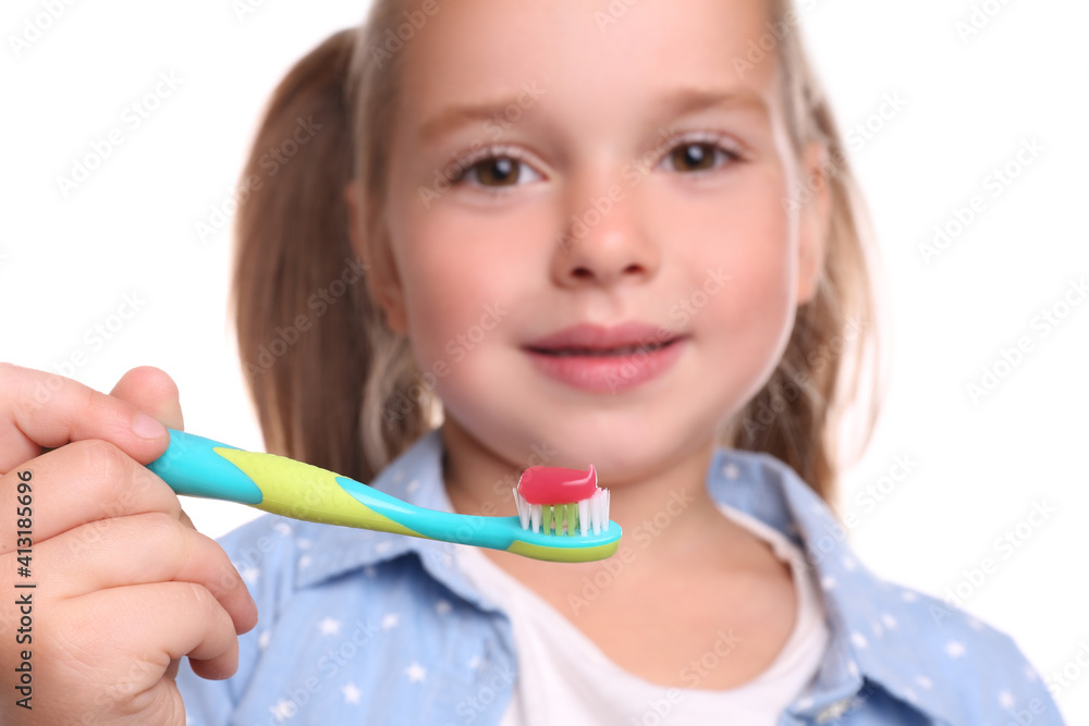 Little girl holding toothbrush with paste on white background, closeup Little girl holding toothbrush with paste on white background, closeup