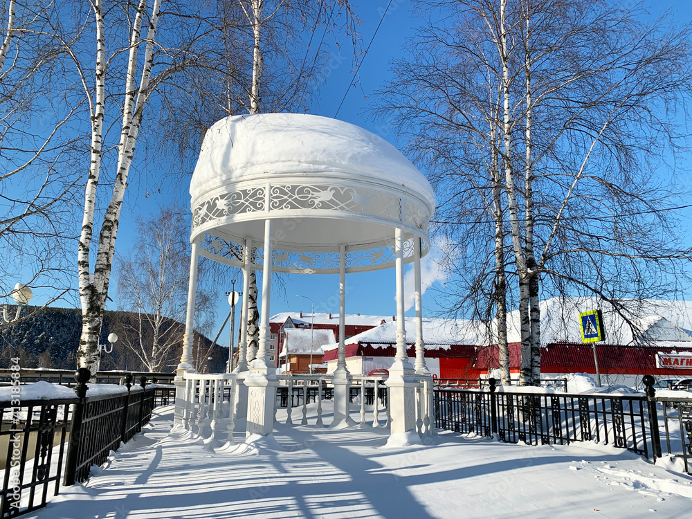 Beautiful white gazebo on the waterfront in the town of Ivdel in the winter. Russia, Sverdlovsk region