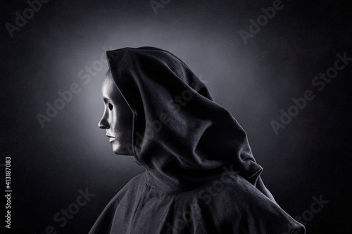 Принти на полотні Scary figure with hooded cloak in the dark