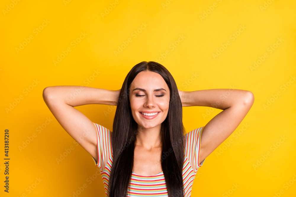 Photo portrait of cheerful woman dreaming sleeping on pause in colorful striped t-shirt isolated on bright yellow color background Photo portrait of cheerful woman dreaming sleeping on pause in colorful striped t-shirt isolated on bright yellow color background