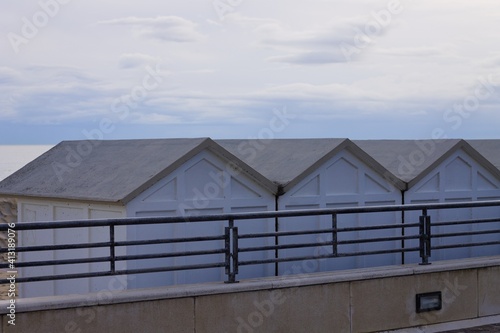 A series of white beach cabins behind a steel fence on the italian coast (Pesaro, Italy, Europe) © Tommaso