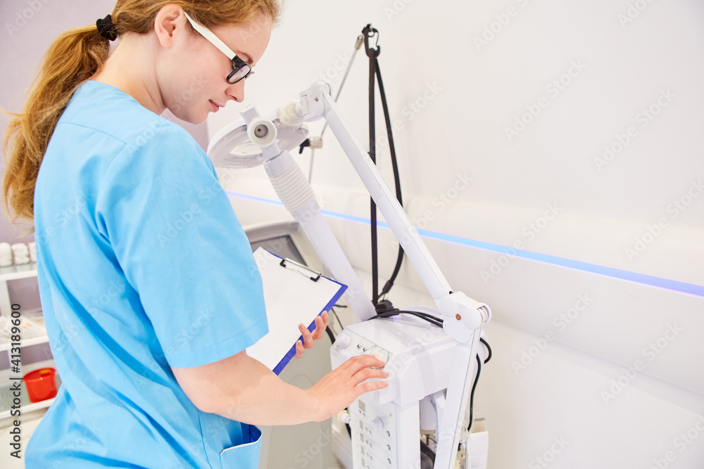 Surgical nurse operates a medical device Stock Photo Adobe Stock