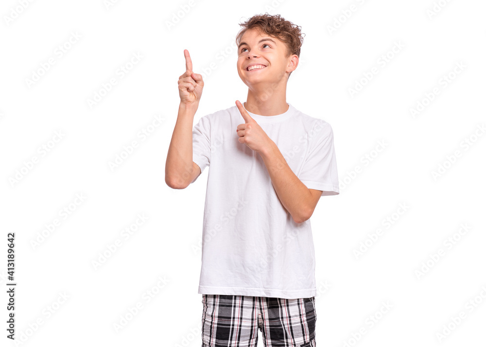 Cute teen boy pointing up, gesturing idea or doing number one gesture, isolated on white background Cute teen boy pointing up, gesturing idea or doing number one gesture, isolated on white background