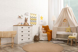 Stylish baby's room with comfortable cot. Interior design