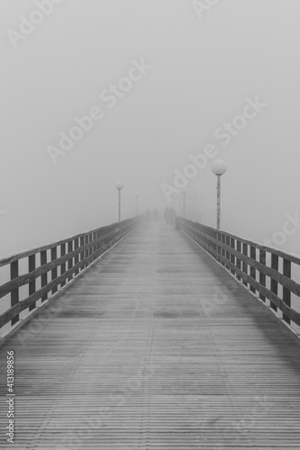Fototapeta Empty Footbridge In Fog Against Sky