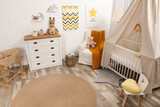 Stylish baby's room with comfortable cot. Interior design