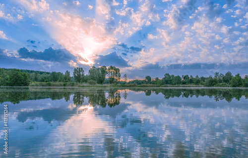 Dawn over a lake or river. Summer morning landscape.