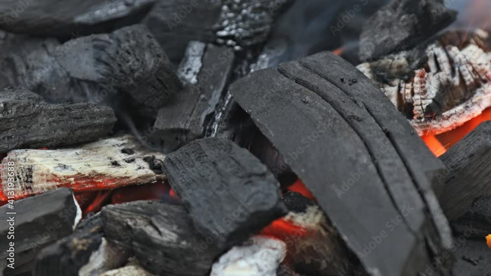Embers glowing in blazing fire burning charcoal close up view Embers glowing in blazing fire burning charcoal close up view