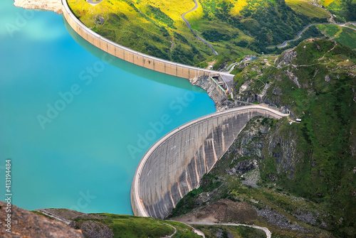 Concrete water dam high in the mountains with blue water, hydroelectric power station