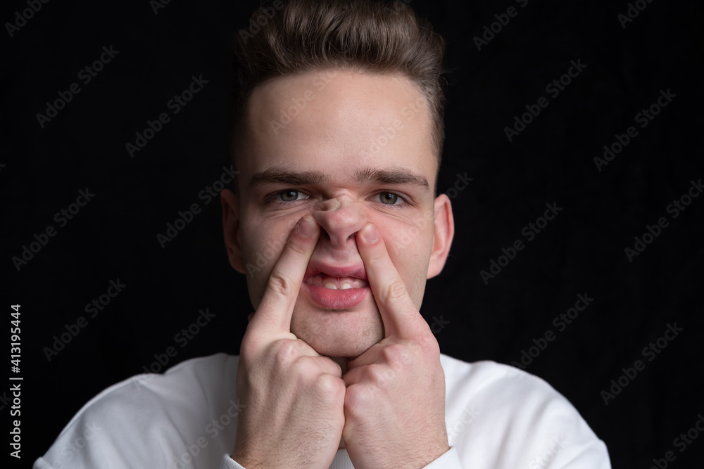 young guy, man, teenager grimaces, makes a nose like a pig young guy, man, teenager grimaces, makes a nose like a pig