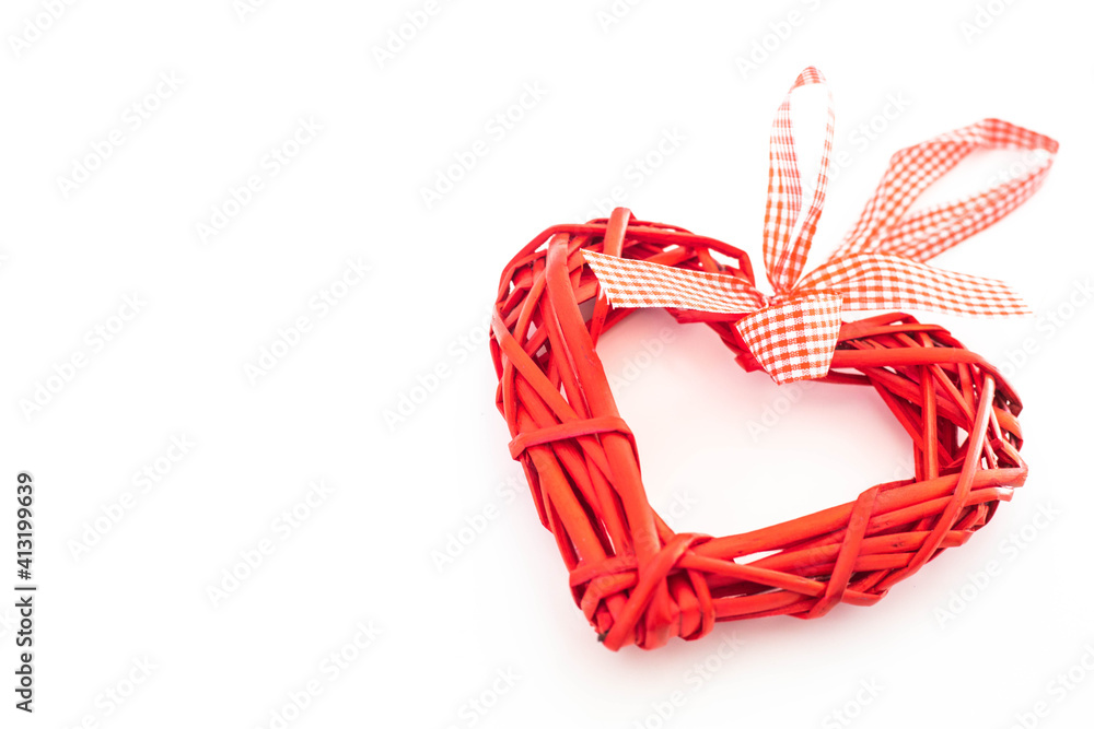 Bright red wicker heart on a solid white background Bright red wicker heart on a solid white background