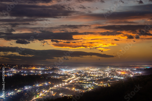 Night city lights in winter at sunset