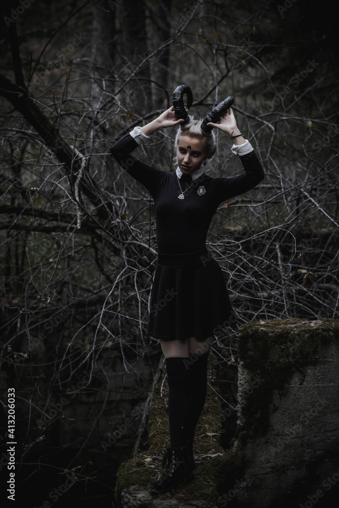 Naklejka premium Witch in the form of a student in the forest