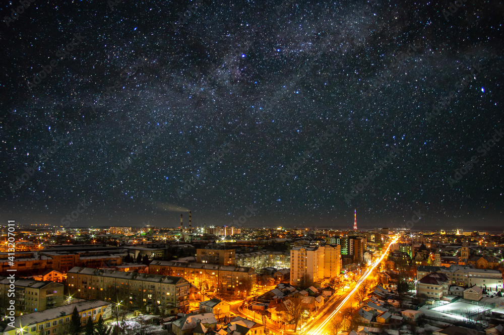 Lights of the night city against the background of a beautiful starry sky in Ukraine