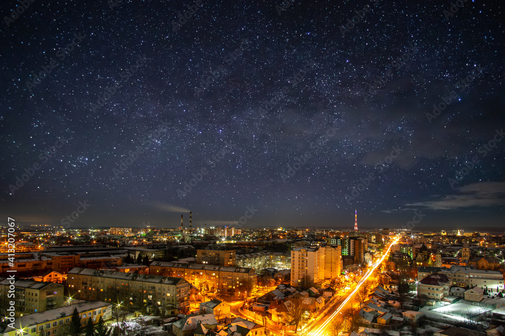 Lights of the night city against the background of a beautiful starry sky in Ukraine
