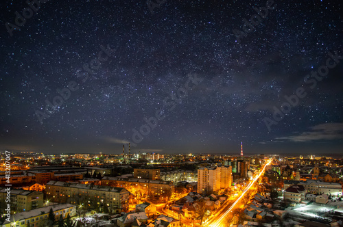 Fototapeta Naklejka Na Ścianę i Meble -  Lights of the night city against the background of a beautiful starry sky in Ukraine