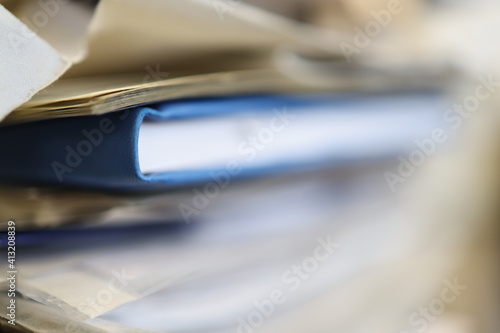 Blue data book, diary, book in a pile of other documents.