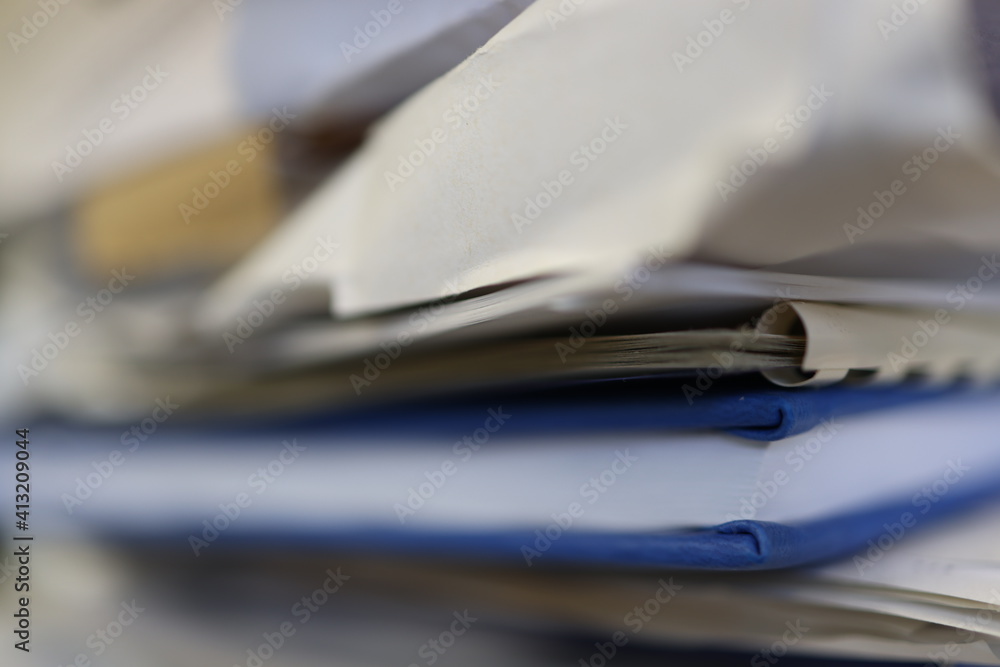 Blue data book, diary, book in a pile of other documents. Blue data book, diary, book in a pile of other documents.