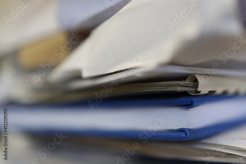 Blue data book, diary, book in a pile of other documents.