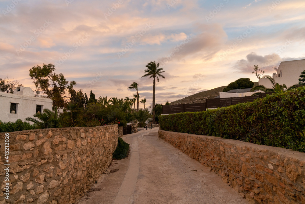 Fototapeta premium road leading to idyllic vacation homes on the Costa del Sol in Agua Amarga in Andalusia at sunset