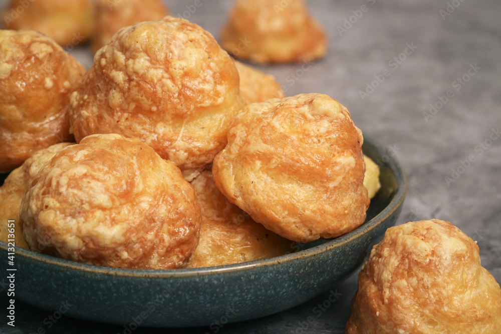 Close up of a bowl of traditional French cheese puff or Gougères. It's a traditional pastry made with savory choux dough. The pastry  know as typically of Burgundy region take as an appetizer. 