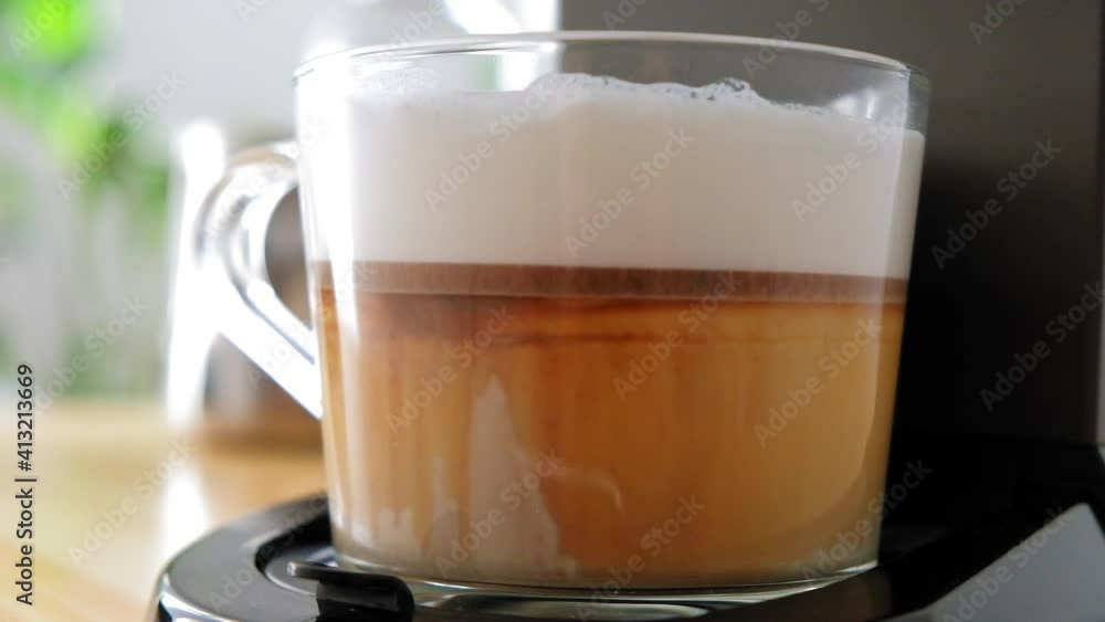 Coffee from a coffee machine is poured into a cup of milk The coffee machine makes a latte Coffee machine makes cappuccino Coffee from a coffee machine is poured into a cup of milk The coffee machine makes a latte Coffee machine makes cappuccino