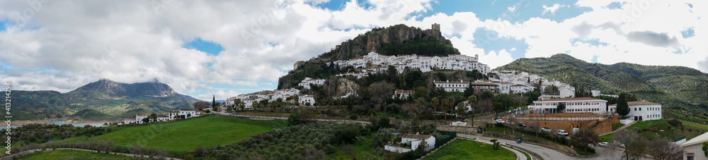 panorama view of the whitwashed Andalusian village of Zahara de la Sierra and its Moorish Castle on the hilltop