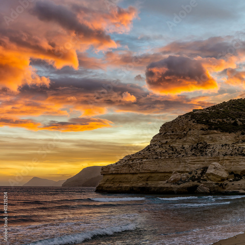 beautiful ocean sunset on the Costa del Sol in Spain with beach and cliffs in the background © makasana photo
