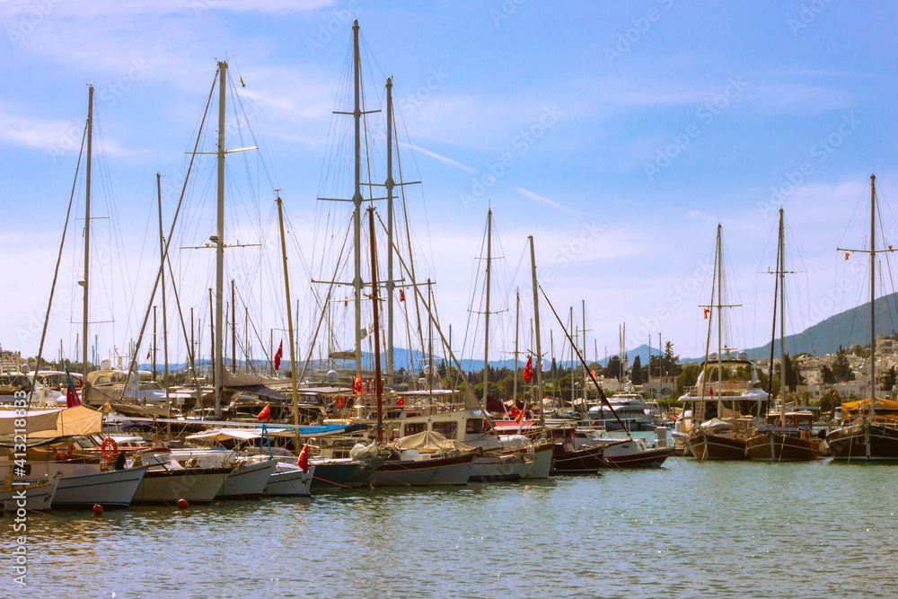 View of many yachts and boats moored at Bodrum harbor in a sunny summer day.