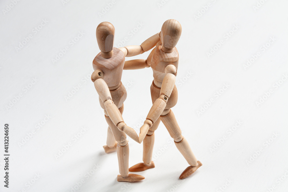 two wooden mannequins dancing and holding hands two wooden mannequins dancing and holding hands