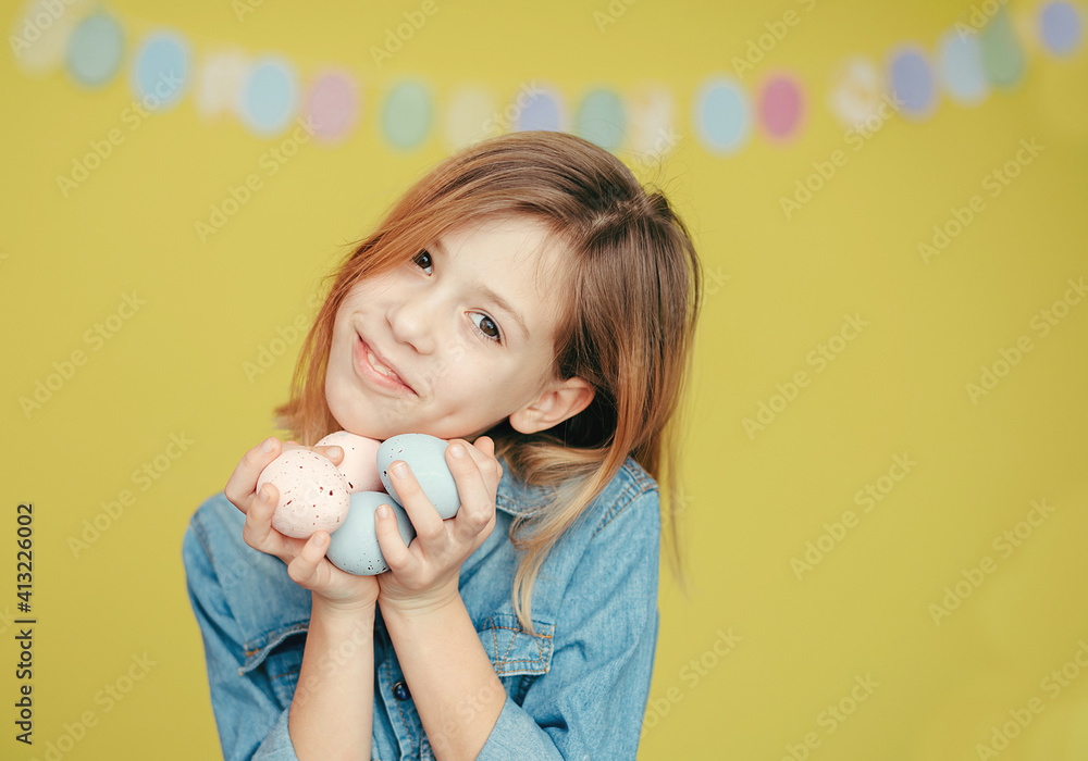 happy girl holding Easter eggs. Yellow background
happy girl holding Easter eggs. Yellow background