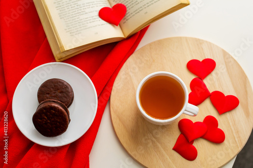 Love concept, cake and heart on a plate and cup of tea, valentine's day, hearts. 