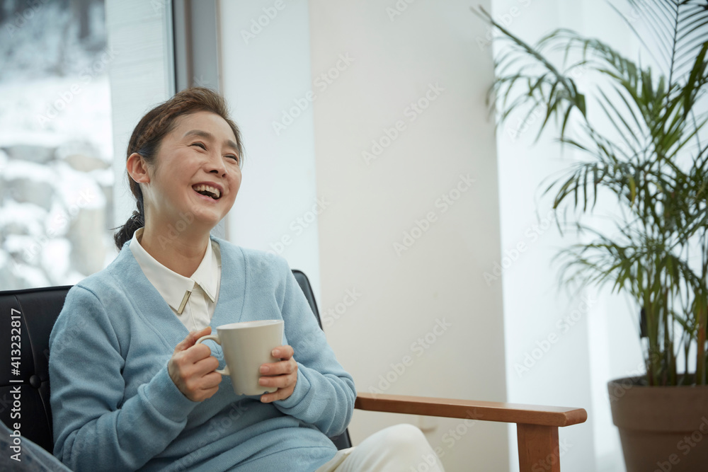 daughter and mother while sitting on sofa at home daughter and mother while sitting on sofa at home
