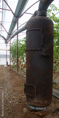 wood burning old stove in a tomatoes greenhouse.