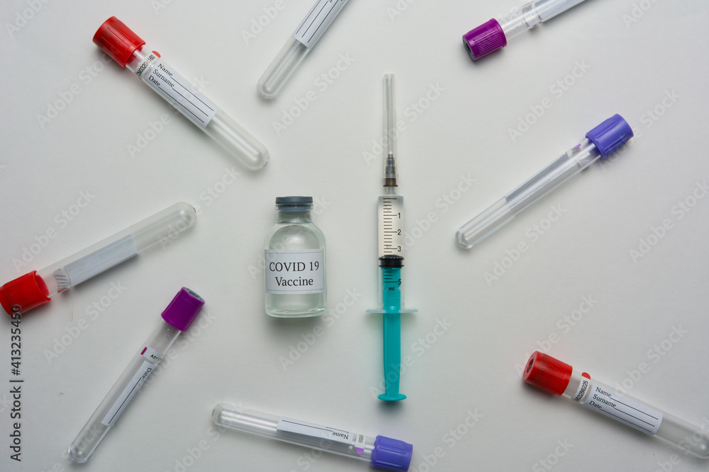 Covid 19 vaccine bottle and syringe on a white background. Covid 19 vaccine bottle and syringe on a white background.