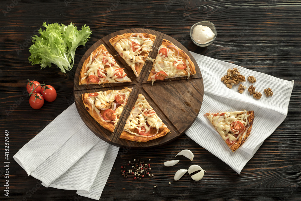 Delicious pizza on a wooden cutting board