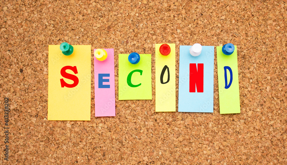Color notes with letters pinned on a board. Word SECOND. Color notes with letters pinned on a board. Word SECOND.