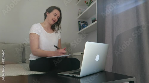 Woman sit on sofa talking to client. Work at home, video call, e-work, counselor, psychologist, therapist, talking to her patient. Stay at home concept.