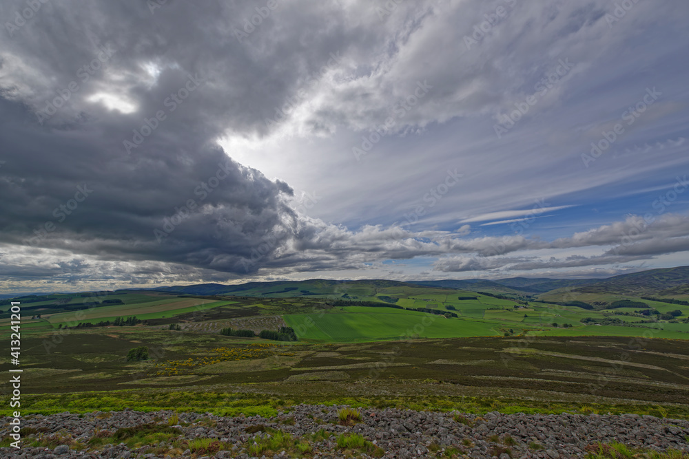 Fototapeta premium Looking North West over the remains of the stone ramparts of the White Caterthun to Glen Esk and the Angus Glens in the distance.