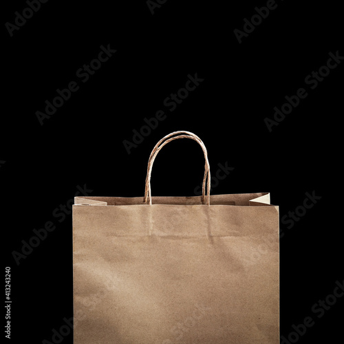 brown shopping paper bag isolated on black background.