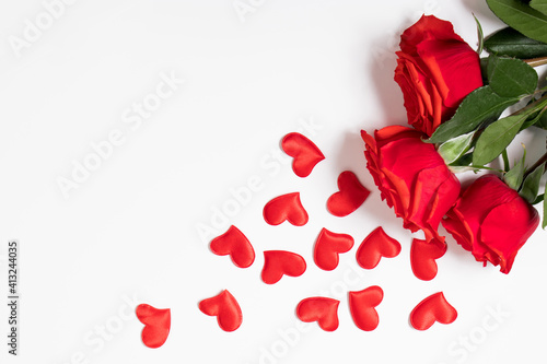 Red roses and hearts on a white background. Valentine's day greeting card. Place for your text.