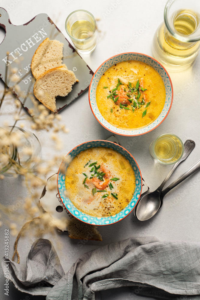 Homemade Finnish salmon soup with cream served with white wine, top view Homemade Finnish salmon soup with cream served with white wine, top view