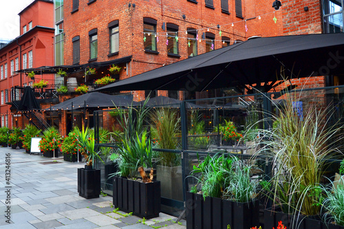 Cozy cafe decorated with green plants. One of the main streets in Oslo, Norway.