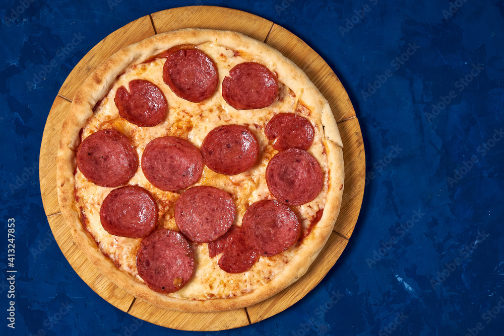 pizza with sausage on a blue background pizza with sausage on a blue background