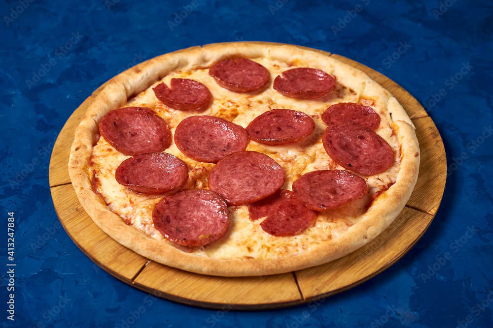 pizza with sausage on a blue background pizza with sausage on a blue background