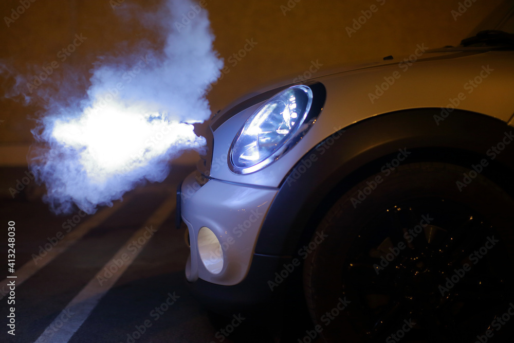 Smoking Headlights from a little car at night, looking angry Stock