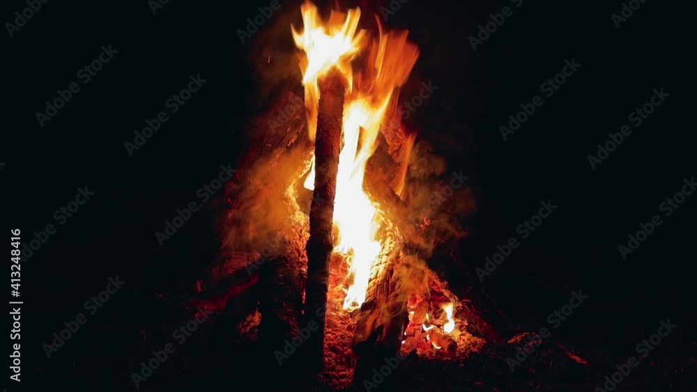Burning Campfire in Night Forest - Close-Up Static Shot. Hot Flaming Bonfire on Black Background Burning Campfire in Night Forest - Close-Up Static Shot. Hot Flaming Bonfire on Black Background