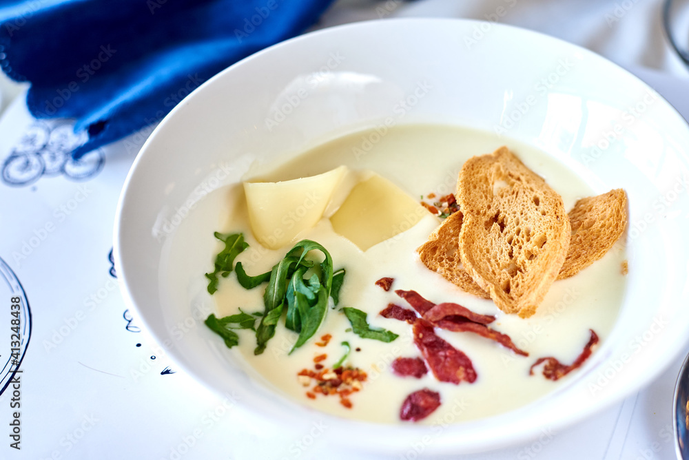 soup with cheese, dandelion leaves and crackers
